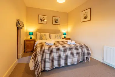 a bedroom with a bed with two towels on it at Marina View, Near Canal and Mountains in Brecon