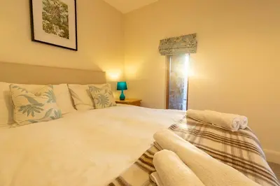 a bedroom with a white bed and a window at Marina View, Near Canal and Mountains in Brecon