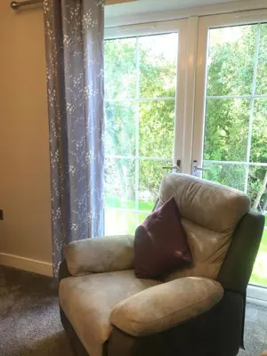 a couch in a living room with a large window at Haul y Bore in Aberystwyth