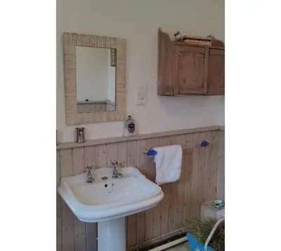 a bathroom with a sink and a mirror at Gaer Hall Guilsfield a country mansion with hottub in Welshpool