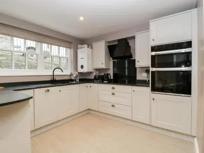 a kitchen with white cabinets and black counter tops at 19 Lion Street in Hereford