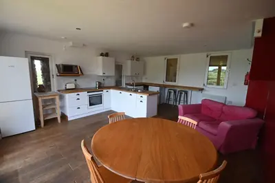 a kitchen and living room with a table and a couch at Hideaway in the Brecon Beacons in Brecon