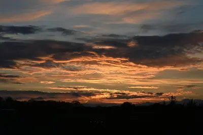a sunset with clouds in the sky at Hideaway in the Brecon Beacons in Brecon