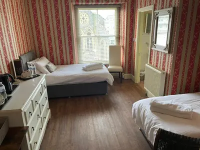 a hotel room with two beds and a window at Tal Y Don Hotel in Barmouth