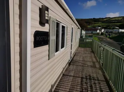 a building with a walkway next to a window at Hiking in Snowdonia? Sea, beach and mountains view in Llwyngwril