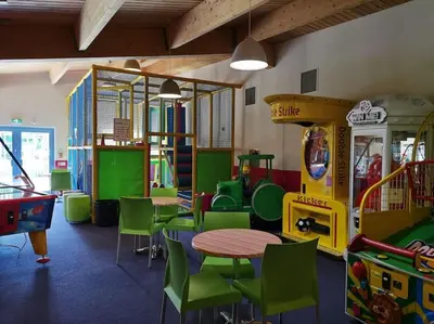 a room with a table and chairs and play equipment at Hiking in Snowdonia? Sea, beach and mountains view in Llwyngwril