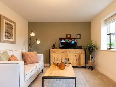 a living room with a couch and a tv at Contemporary 2 bedroom home - Pass the Keys in Ludlow