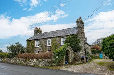 an old stone house on the side of the road at Ty Mawr Llanfair in Llanfair