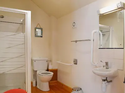 a bathroom with a toilet and a sink at Granary Cottage in Oswestry