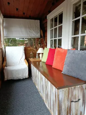 a wooden bench with colorful pillows on it in a room at 299 Willow Lodge in Trawsfynydd