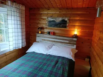 a bedroom with a bed in a log cabin at 299 Willow Lodge in Trawsfynydd