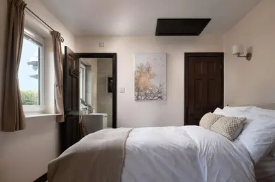 a bedroom with a white bed and a window at Lake House in Brecon