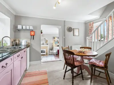 a kitchen with a table and chairs and a dining room at The Coach House- Uk45660 in Bishops Castle