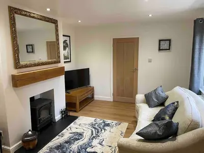 a living room with a fireplace and a mirror at Branlea - In the Heart of Ludlow in Ludlow