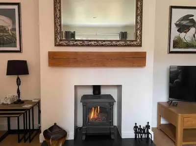 a living room with a fireplace and a mirror at Branlea - In the Heart of Ludlow in Ludlow