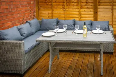 a table with wine glasses and a couch at Branlea - In the Heart of Ludlow in Ludlow