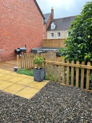 a wooden fence with a potted plant in a yard at Branlea - In the Heart of Ludlow in Ludlow