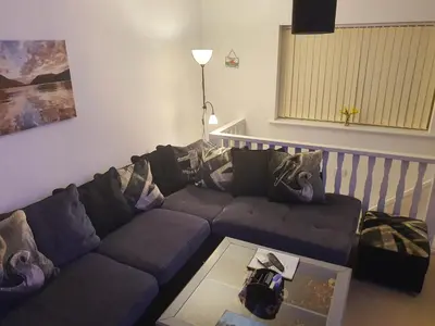 a living room with a couch and a table at Idyllic 2 Bedroom Self-Contained UpsideDown Annexe in Llandrindod Wells