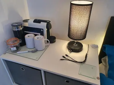 a desk with a lamp and a cup on it at Idyllic 2 Bedroom Self-Contained UpsideDown Annexe in Llandrindod Wells