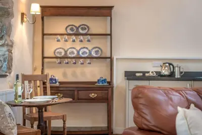 a living room with a table and a couch at Stabal-Byrdir in Dyffryn