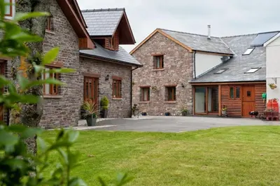a large brick house with a large driveway at Oak Barn in Brecon