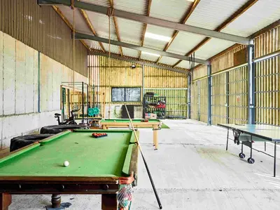 a room with a pool table in a building at Sycamore Tree Barn in Brecon