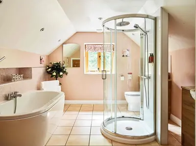 a bathroom with a shower and a tub and a toilet at Sycamore Tree Barn in Brecon