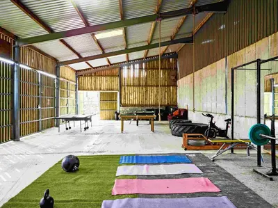 a large room with mats on the floor of a gym at The Orient Express Shepherd's Hut with Hot Tub in Brecon