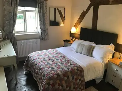 a bedroom with a large bed and a window at Ty Twty, Montgomery Cottage in Montgomery