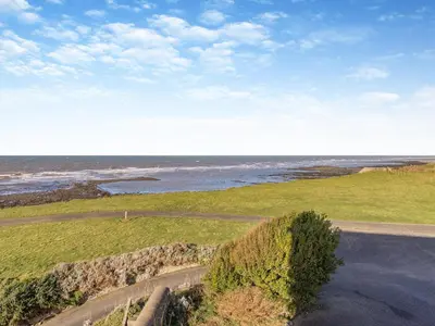 an aerial view of the ocean and a road at Morlais in Llanon