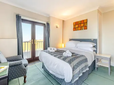 a hotel room with a bed and a balcony at Morlais in Llanon