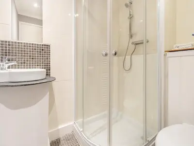 a bathroom with a shower and a sink at Morlais in Llanon