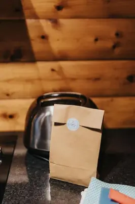 a bag sitting on a counter next to a toaster at Rustic Log Cabin in Snowdonia - 2 Bedrooms & Parking in Ffestiniog