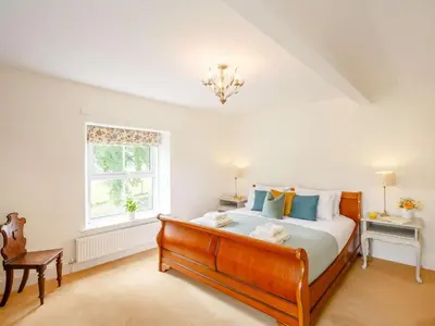 a bedroom with a large bed and a window at 4 Bed in Corwen oc-88868 in Corwen