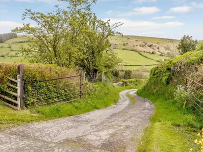 a dirt road in the hills with a fence at 2 Bed in Brecon oc-bn310 in Cray
