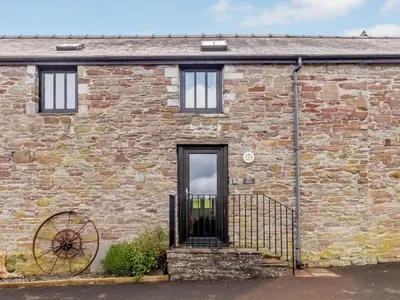 a brick house with a black door and a window at 2 Bed in Brecon oc-bn310 in Cray