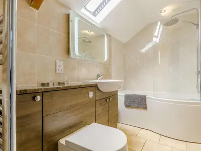a bathroom with a toilet and a sink and a tub at 2 Bed in Brecon oc-bn310 in Cray