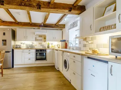a kitchen with white cabinets and white appliances at 2 Bed in Brecon oc-bn310 in Cray