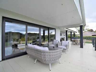 a porch with chairs and tables on a house at 4 Bed in Oswestry oc-75175 in Kinnerley