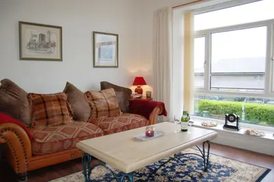 a living room with a couch and a coffee table at Beach Vista Apartment One in Barmouth in Barmouth