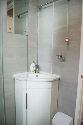 a bathroom with a white sink and a toilet at Bryniau Gwyrdd Chalet 11 Happy Valley in Tywyn