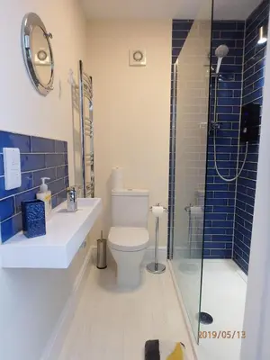 a bathroom with a toilet and a sink and a shower at Bryn Mair in Barmouth in Barmouth