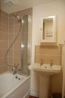 a bathroom with a sink and a shower and a tub at Bronhaul Cottage in Pennal in Pennal