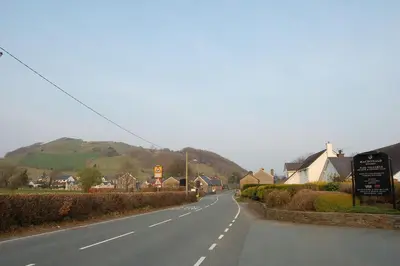 an empty road in a small town with houses at Bronhaul Cottage in Pennal in Pennal