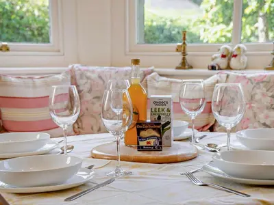 a table with glasses and a bottle of wine on it at 3 Bed in Brecon oc-bn134 in Brecon