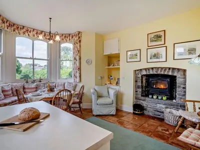 a living room with a fireplace and a table at 3 Bed in Brecon oc-bn134 in Brecon