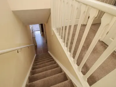 a staircase in a house with white railings at Ludlow House in Ludlow