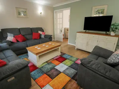 a living room with two couches and a tv at Ludlow House in Ludlow