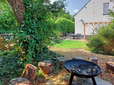 a table and chairs in a yard with a tree at Ty Capel in Tywyn in Tywyn