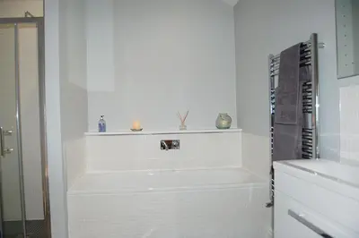 a white bathroom with a tub and a keyboard at Anneddle Cottage in Talybont, near Barmouth in Talybont